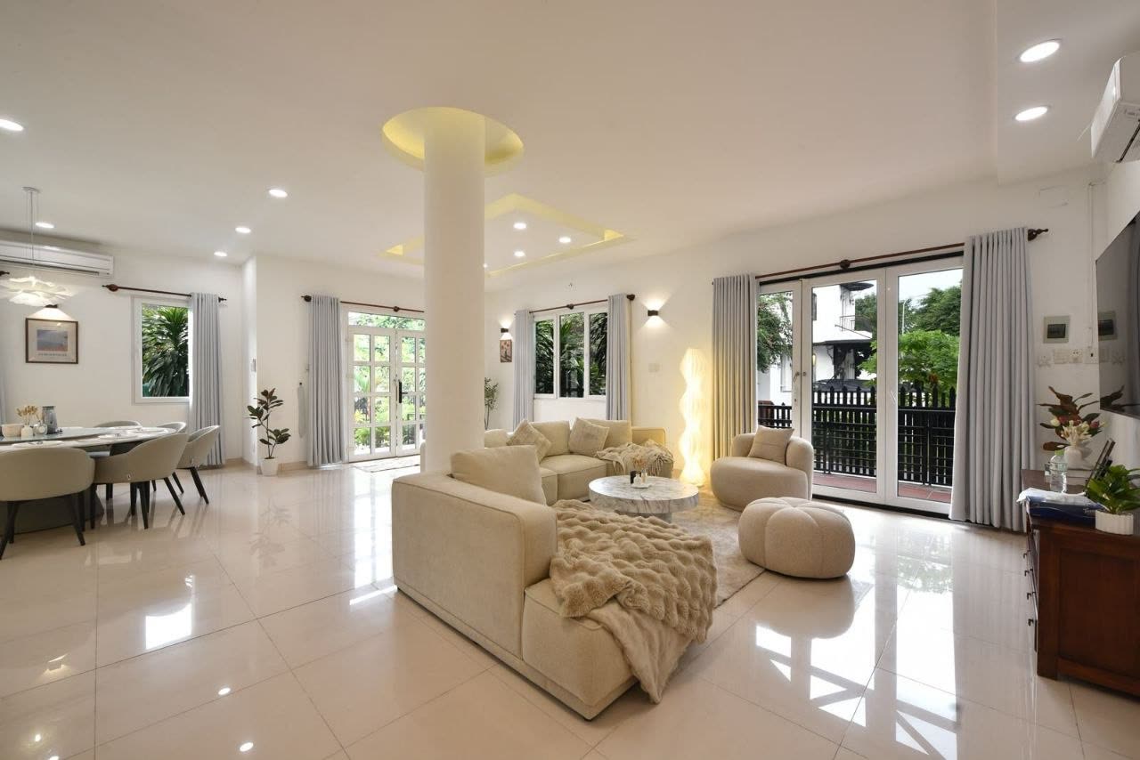Bright living room with white sofas and a glossy floor