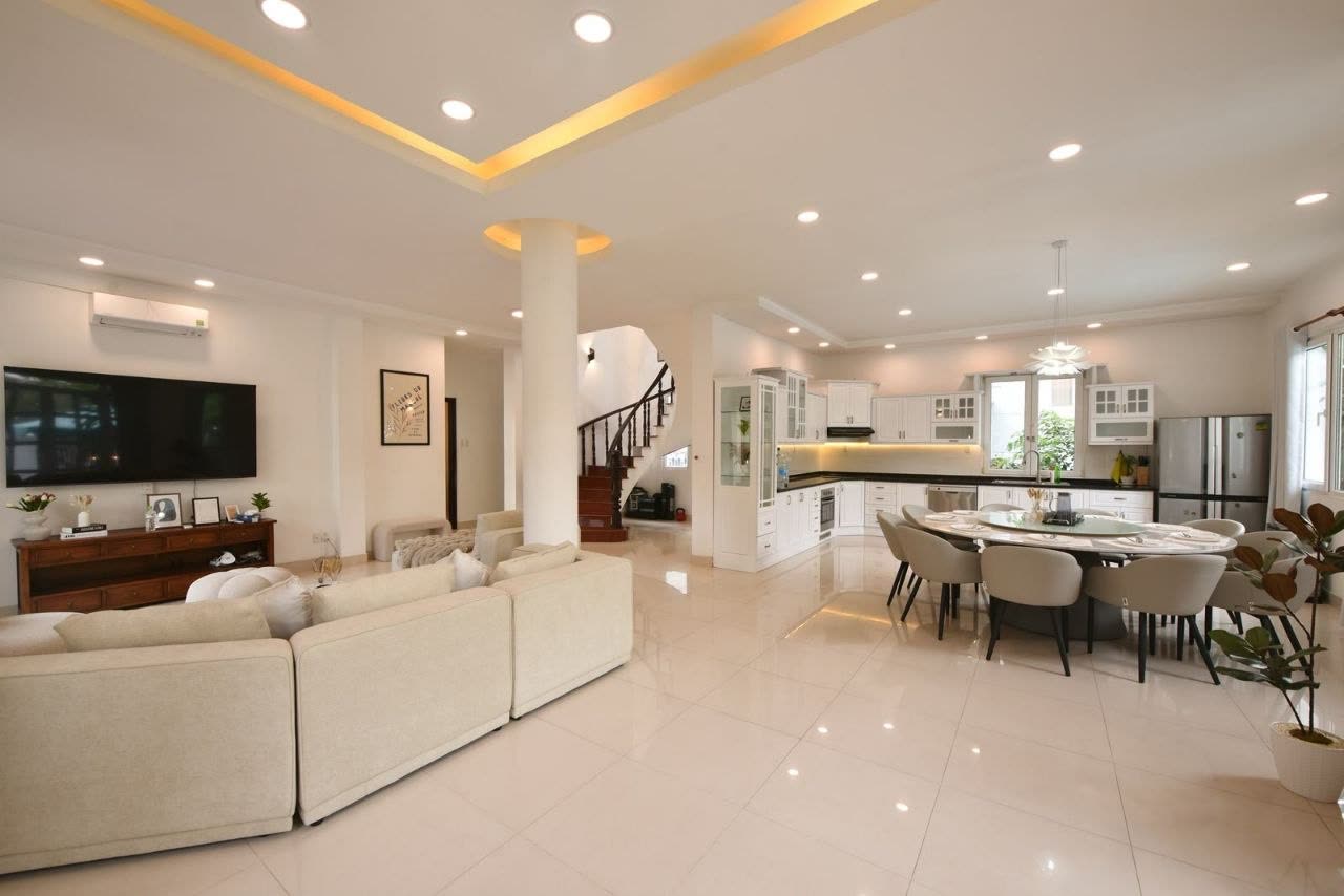 Open-plan living room and kitchen with a wall-mounted TV