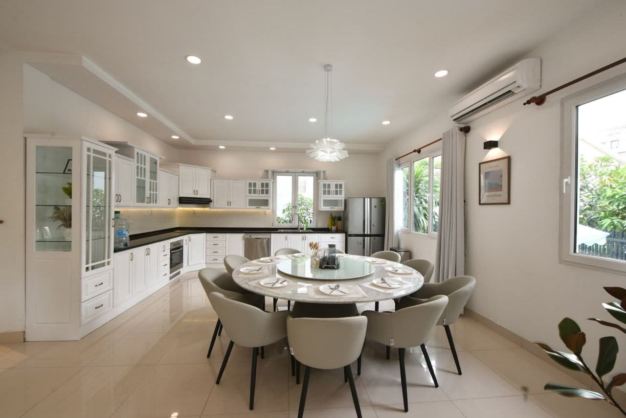 Round dining table for eight beside the open kitchen