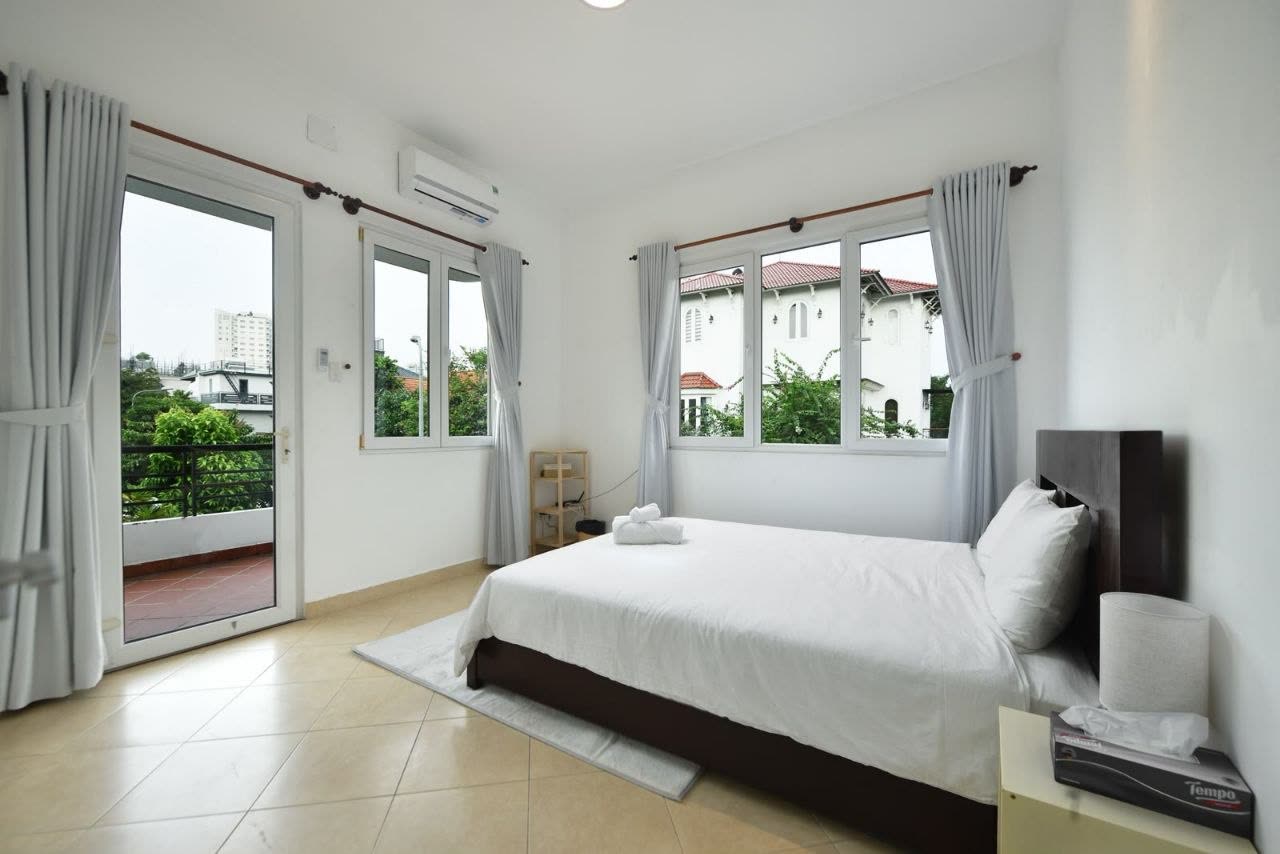 Bedroom with a queen bed and a door onto the balcony