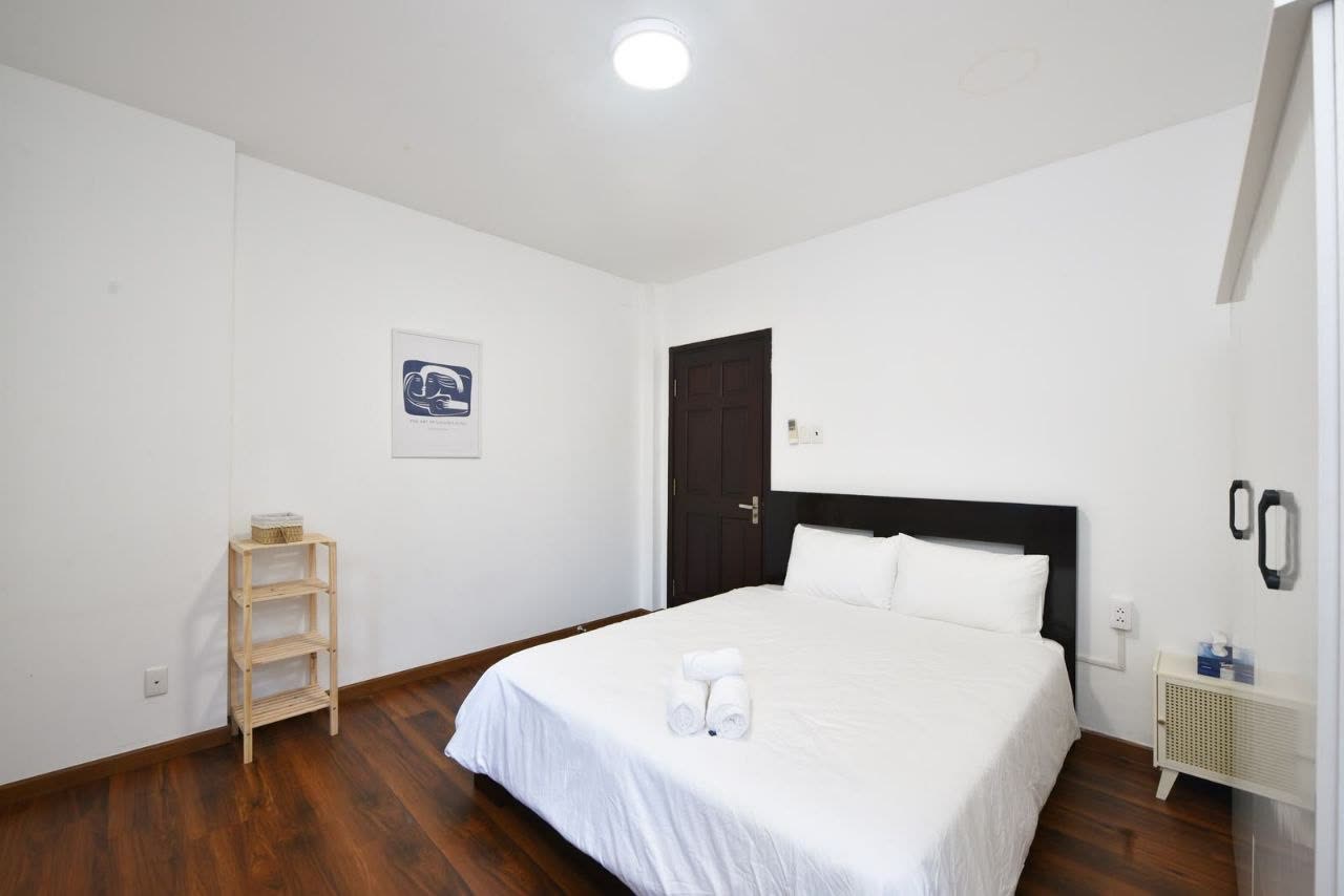 Bedroom 4, white room with a queen bed and wardrobe