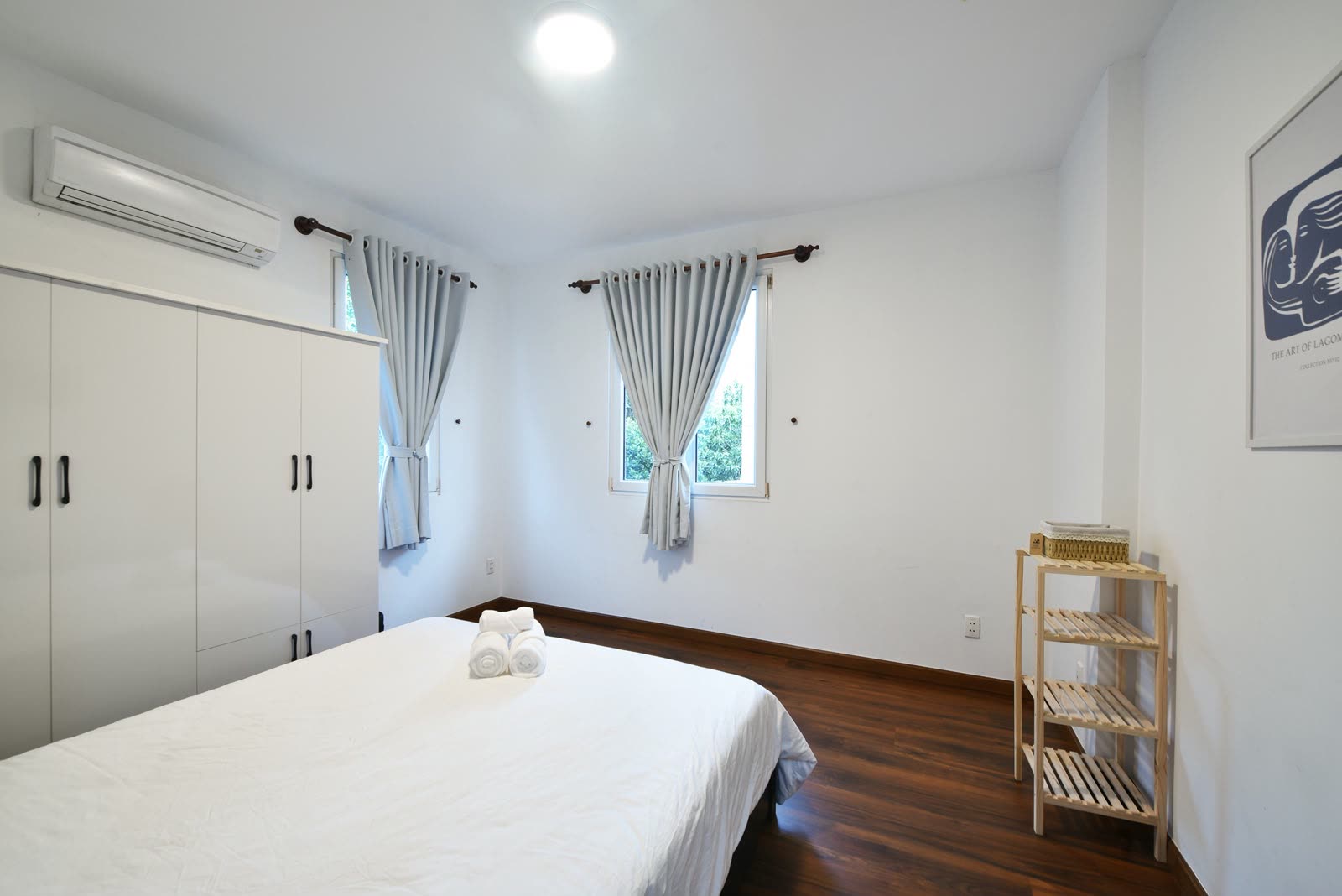 Bedroom with a queen bed, white wardrobe and air conditioning