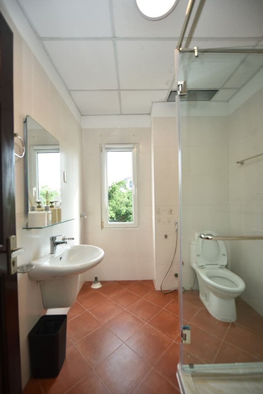 Small bathroom with a sink, toilet and a window
