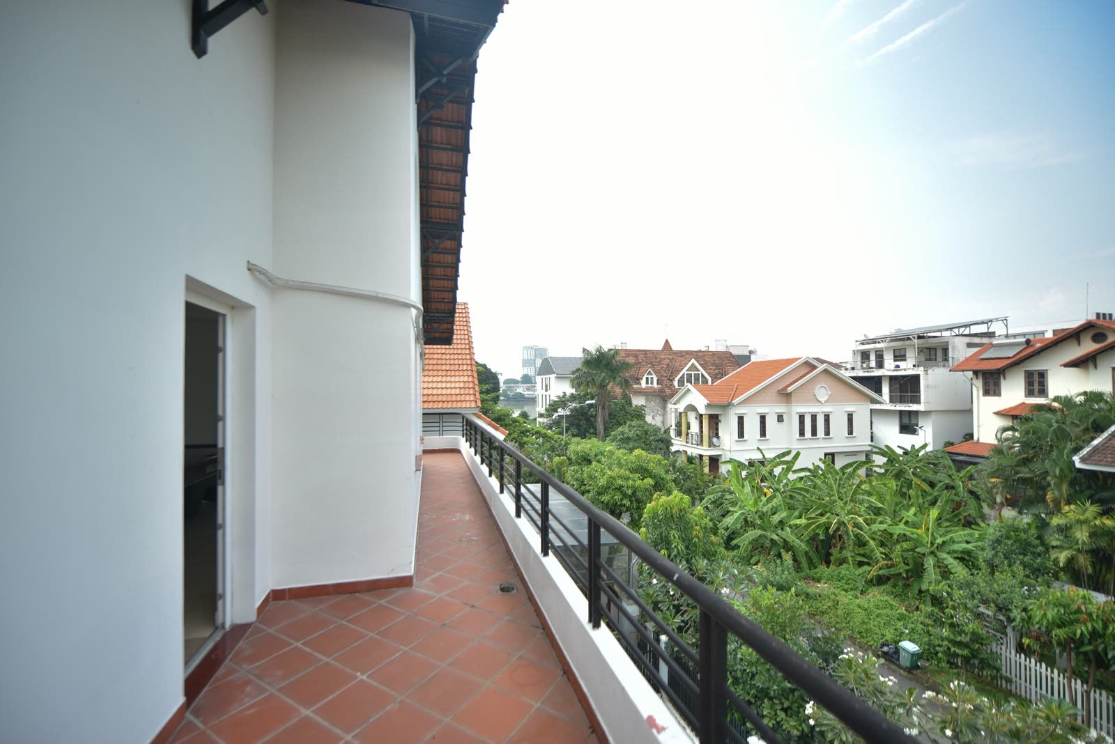 Covered balcony with terracotta floor looking over the neighbourhood