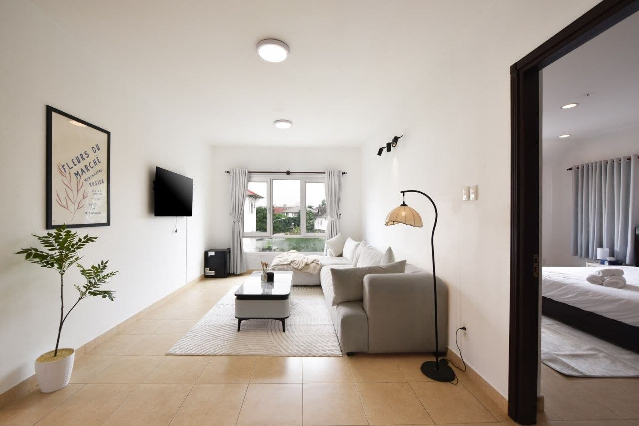 Upstairs lounge with a sofa, TV and a floor lamp