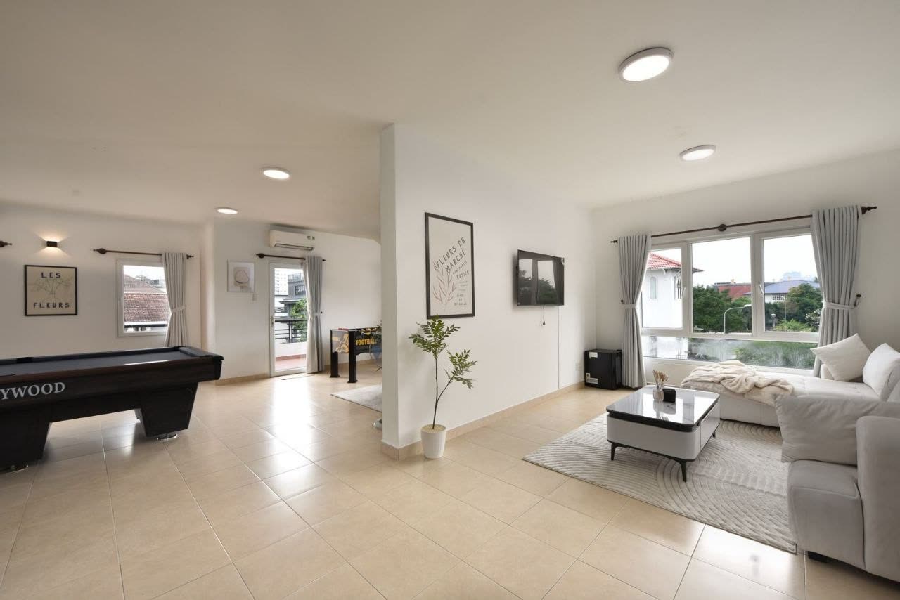 Upstairs lounge with a pool table and a sofa