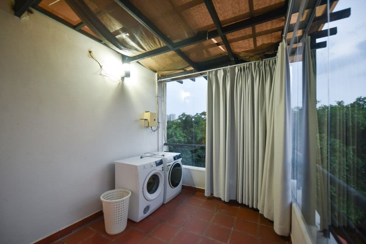 Laundry corner with a washer and dryer under a glass roof